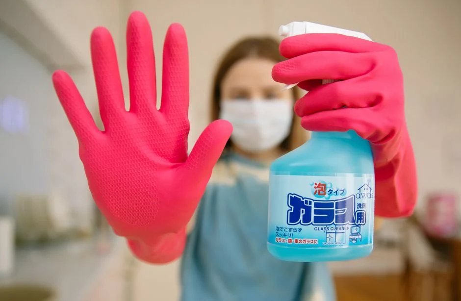 An Asian couple having fun while cleaning their home, helping create a cheerful atmosphere.